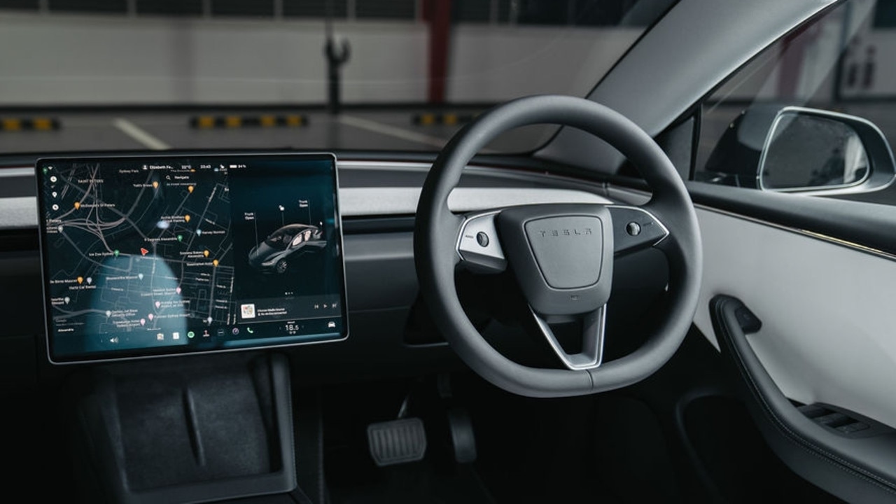 Tesla has made the steering wheel even more minimal by removing the indicator and gear selector stalks., Tesla has made broad changes inside and out., Tesla will start deliveries of the new Model 3 in January., Technology, Motoring, Motoring News, 2024 Tesla Model 3 revealed in Australia