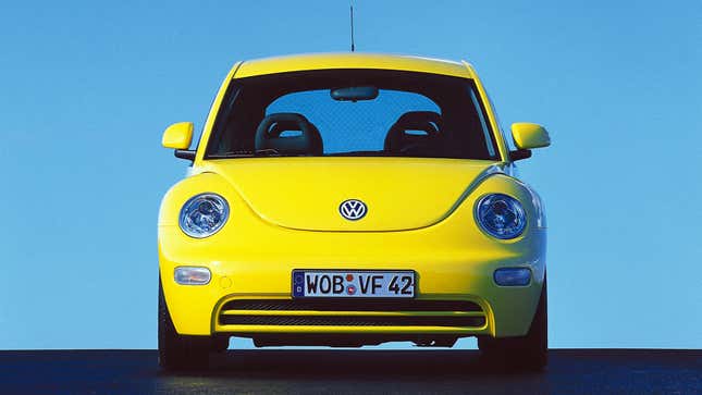 A photo of a yellow Volkswagen Beetle. 